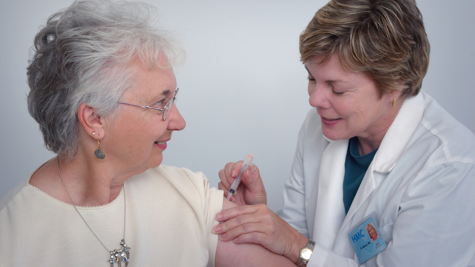 Hands gently supporting an elderly person — care, dignity, human connection
